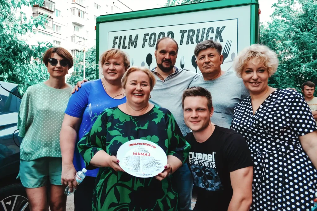 A group photo of the Osnova Film Production team led by Valentyna Rudenko, with actors and crew during the filming of the 'Mama 2' TV series.